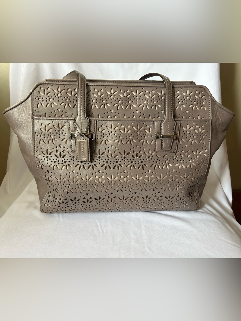 Coach Taylor Bette Eyelet leather tote bag in a putty or beige color.